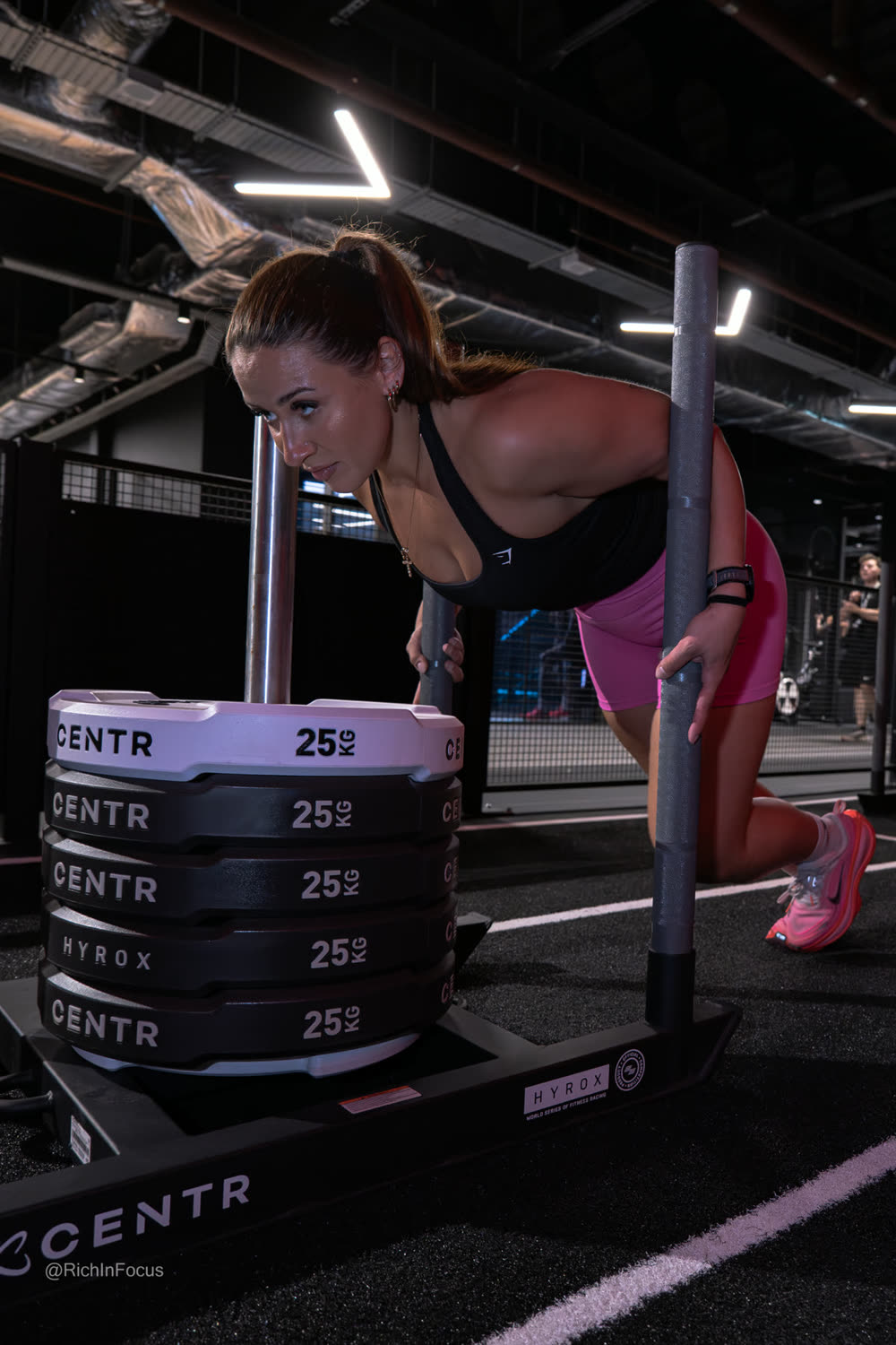 An athlete pushing a loaded sled at the HYROX Performance Centre